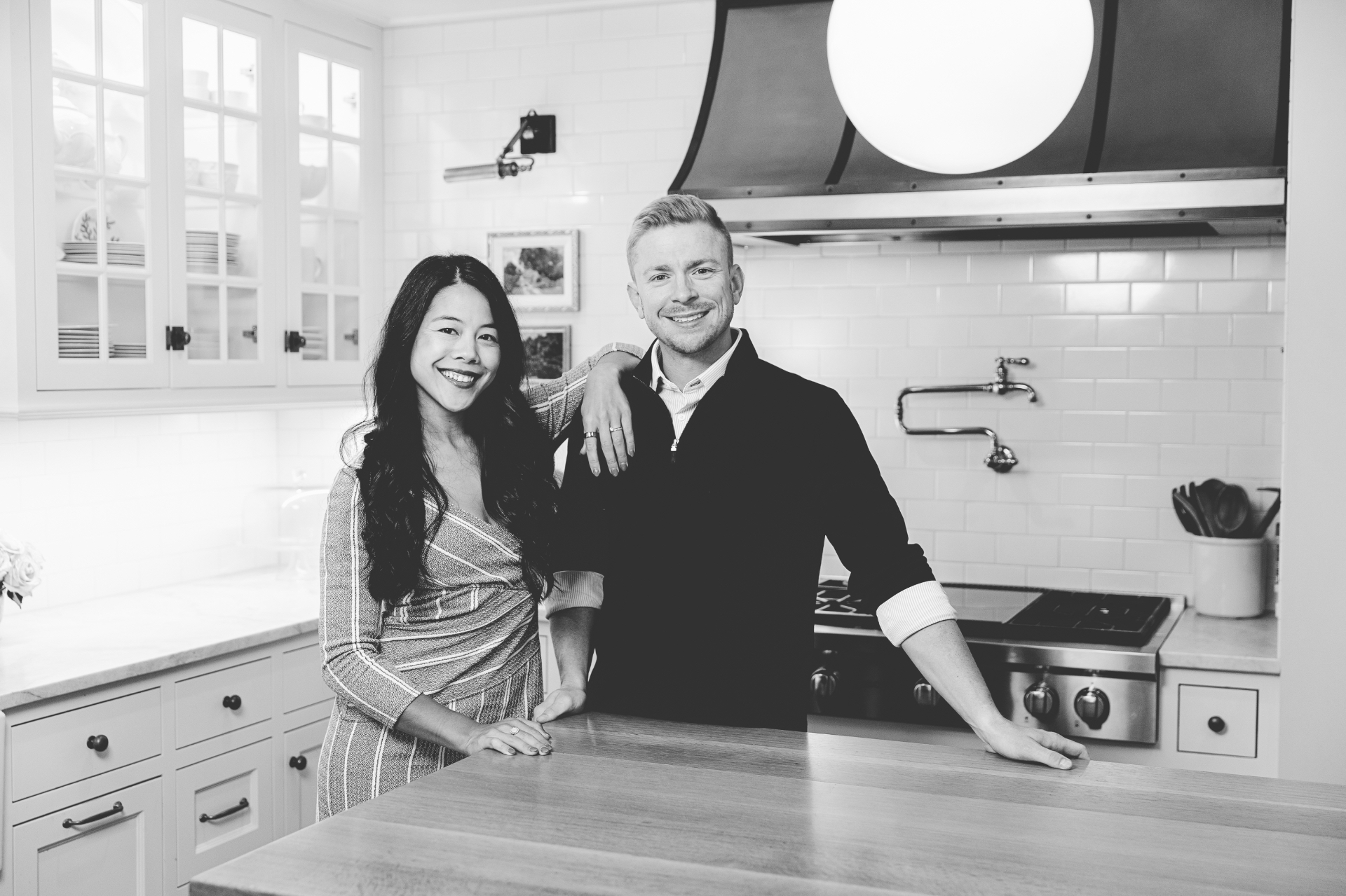 CJ and Katy Norman standing together in their kitchen
